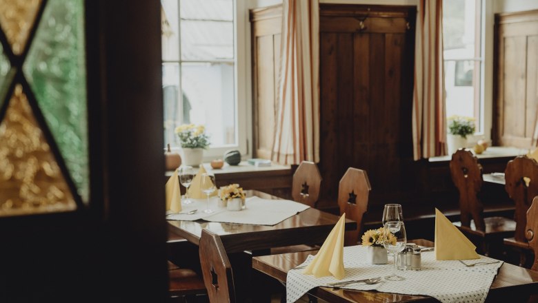 Hereinspaziert in den Wiener Alpen, © Niederösterreich Werbung/Sophie Menegaldo Gemütliches Restaurant mit Holzmöbeln und gedeckten Tischen.