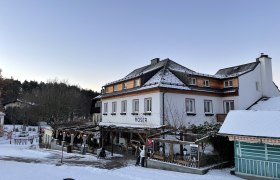 Gasthaus Moser im Winter mit Schnee bedeckt.